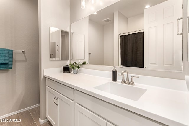 bathroom with visible vents, recessed lighting, vanity, and baseboards