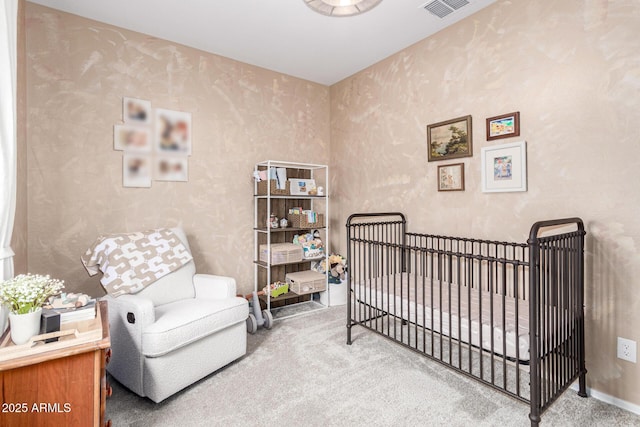 bedroom with visible vents, a crib, carpet flooring, wallpapered walls, and baseboards