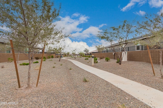 view of property's community with a residential view and fence