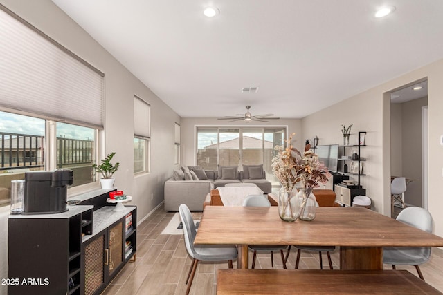 dining area featuring plenty of natural light, baseboards, visible vents, and wood finish floors