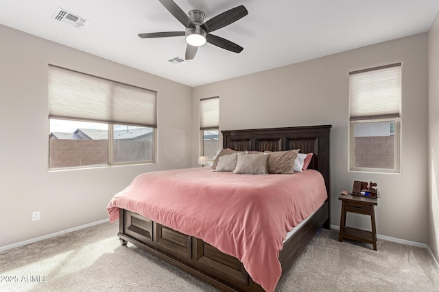 bedroom with visible vents, baseboards, and light colored carpet