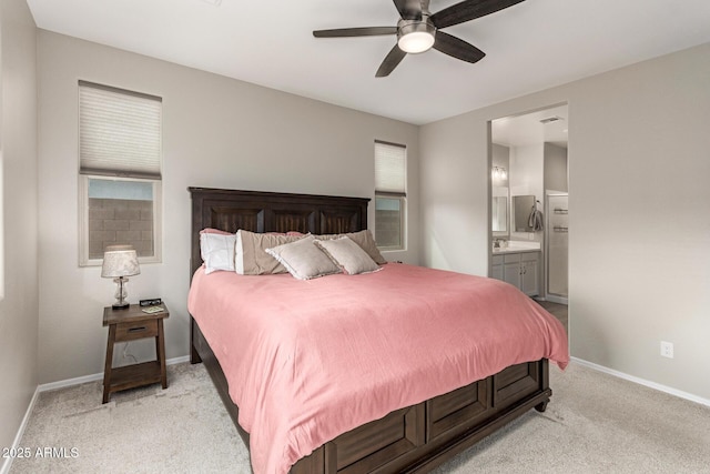 bedroom with light carpet, visible vents, connected bathroom, and baseboards