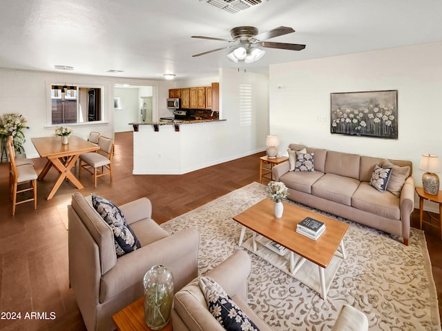 living room featuring hardwood / wood-style floors and ceiling fan