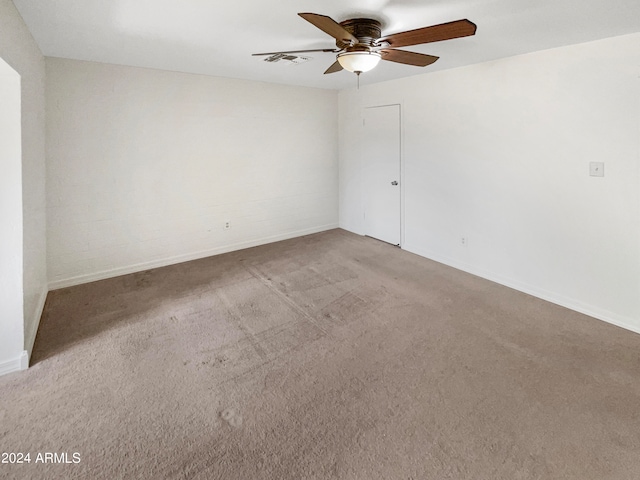 carpeted spare room with ceiling fan