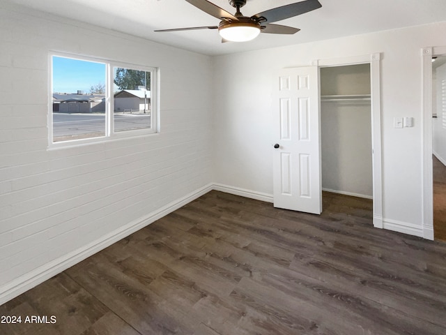 unfurnished bedroom with a closet, ceiling fan, and dark hardwood / wood-style flooring