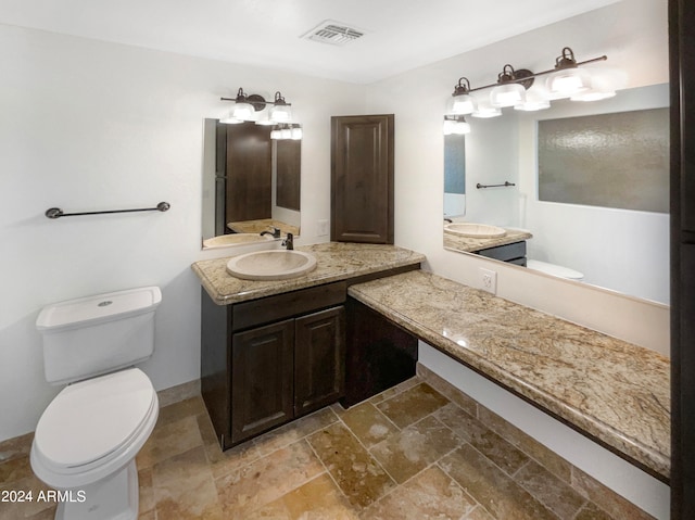 bathroom with vanity and toilet