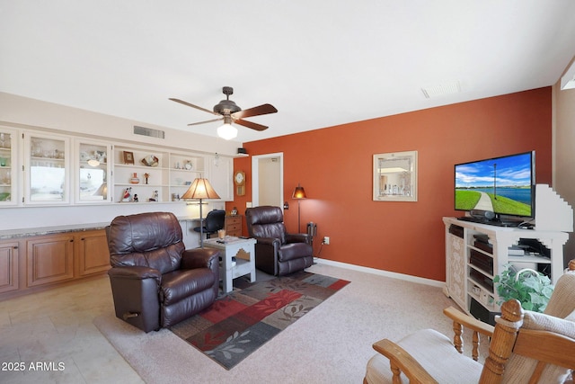 living room featuring ceiling fan and built in shelves