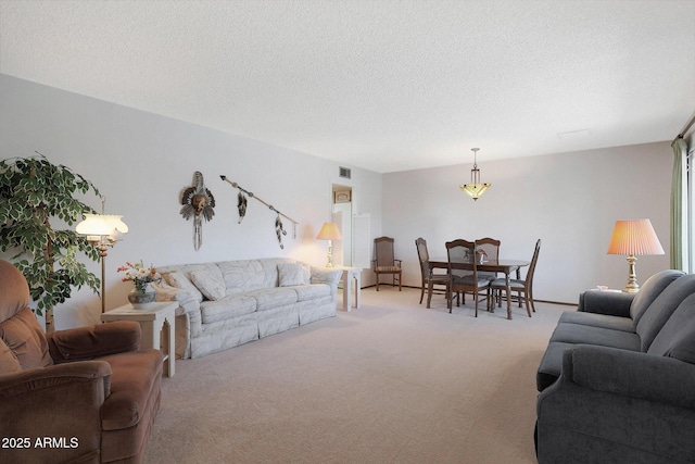 living room featuring a textured ceiling and light colored carpet