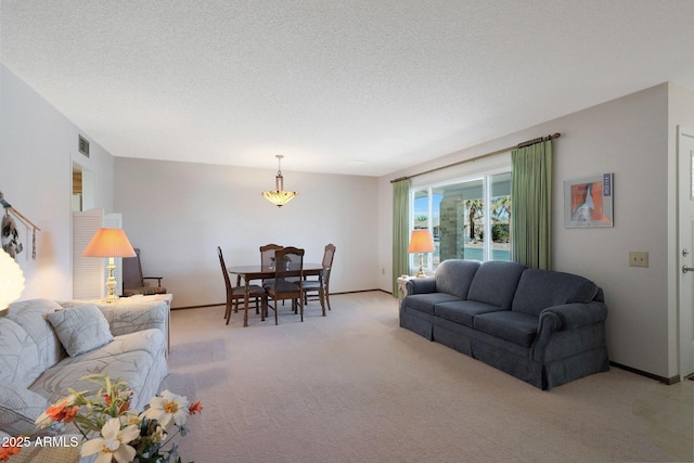 carpeted living room featuring a textured ceiling