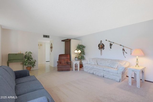 living room with a textured ceiling and light carpet