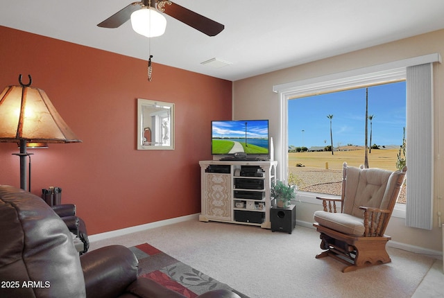 carpeted living room featuring ceiling fan and a healthy amount of sunlight