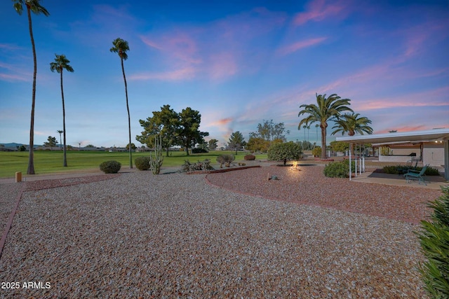 yard at dusk with a patio