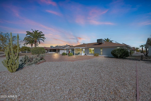 single story home featuring central air condition unit