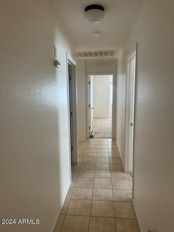 hallway featuring light tile patterned floors