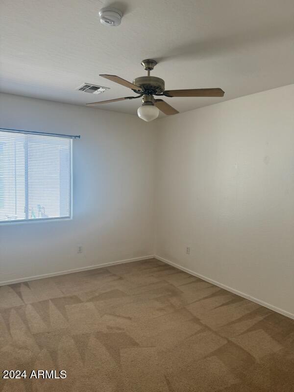 carpeted empty room with ceiling fan