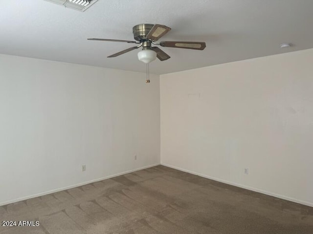 carpeted spare room with ceiling fan