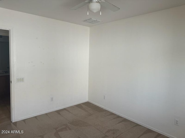 empty room with carpet and ceiling fan