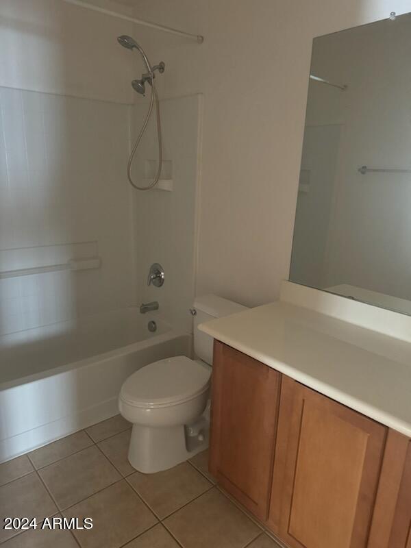 full bathroom with tub / shower combination, tile patterned floors, vanity, and toilet