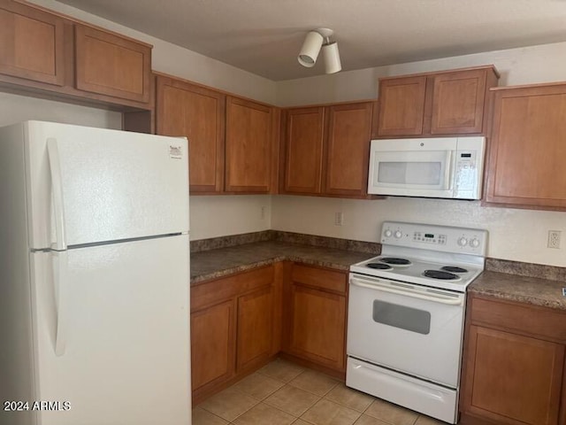 kitchen featuring white appliances and light tile patterned floors