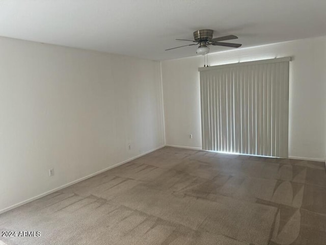 unfurnished room featuring carpet and ceiling fan