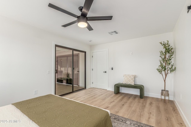unfurnished bedroom featuring a closet, light wood-type flooring, ceiling fan, baseboards, and visible vents