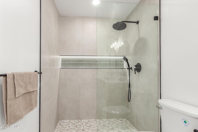 full bathroom with toilet and tiled shower