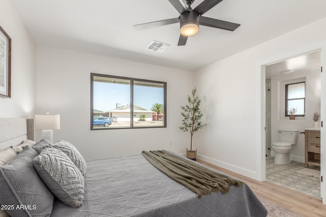 bedroom featuring connected bathroom, ceiling fan, wood finished floors, and visible vents