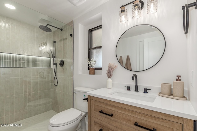 bathroom featuring toilet, vanity, and a walk in shower
