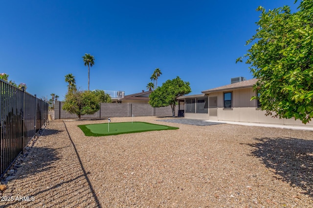 view of yard featuring a fenced backyard and a sunroom