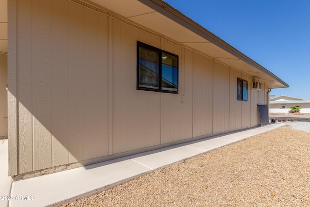 view of property exterior featuring an AC wall unit