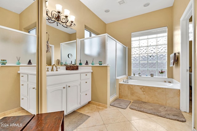 bathroom with vanity, tile patterned flooring, and plus walk in shower