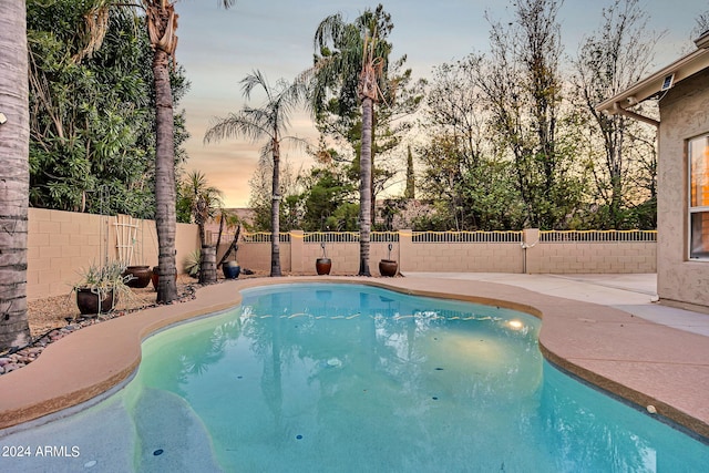 view of pool at dusk