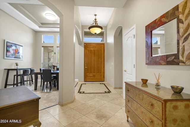 entrance foyer with a high ceiling and light tile patterned flooring