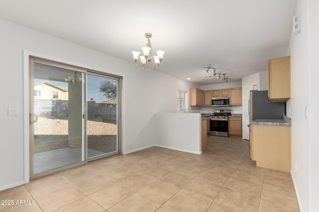 kitchen featuring hanging light fixtures, light tile patterned floors, stainless steel appliances, and a notable chandelier