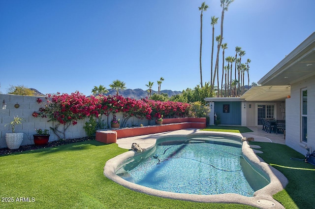 view of pool featuring a lawn and a patio