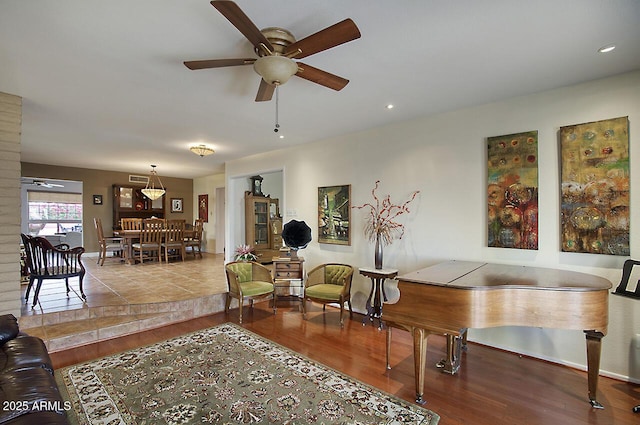 living room featuring ceiling fan and light wood-type flooring