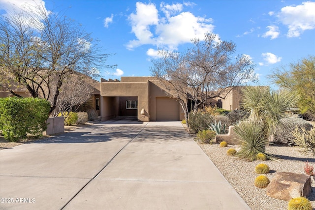 pueblo-style house with a garage