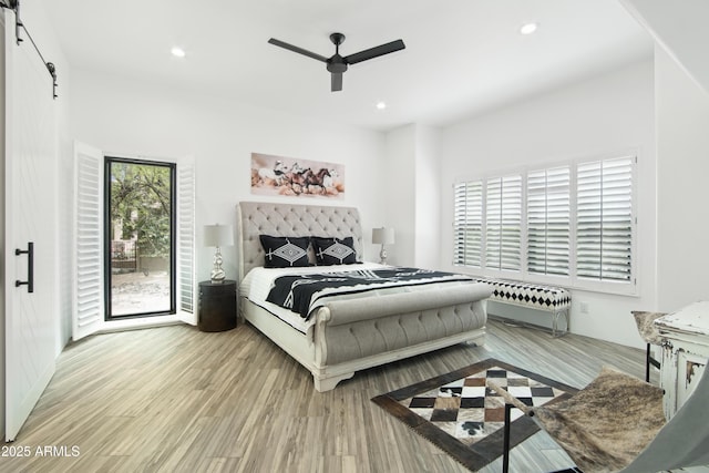 38953 N 57th Pl, Cave Creek, AZ 85331 - bedroom featuring a barn door, wood finished floors, recessed lighting, and ceiling fan