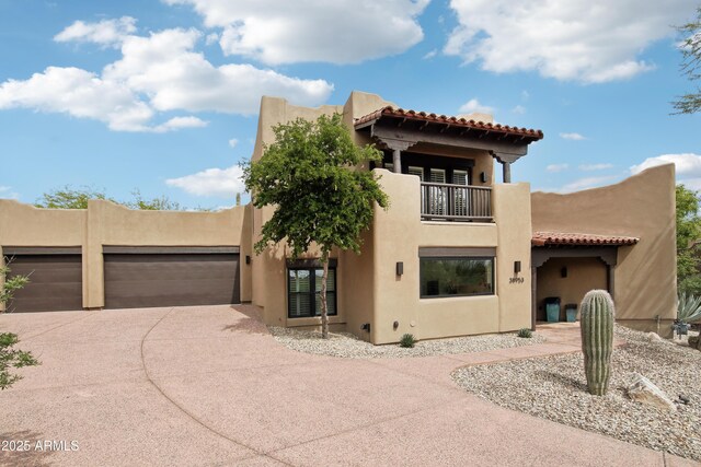 38953 N 57th Pl, Cave Creek, AZ 85331 - view of front of house with a balcony, stucco siding, a tile roof, and driveway