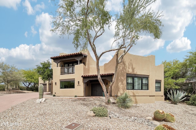 38953 N 57th Pl, Cave Creek, AZ 85331 - view of front of property featuring a balcony, stucco siding, a tiled roof, and driveway