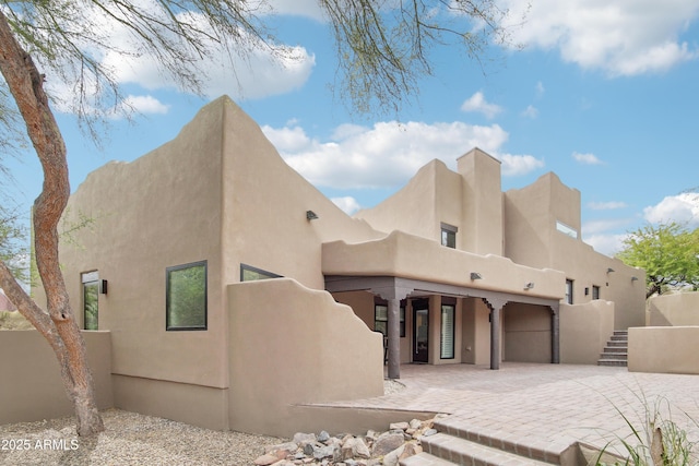 38953 N 57th Pl, Cave Creek, AZ 85331 - rear view of property with driveway, stucco siding, and a garage