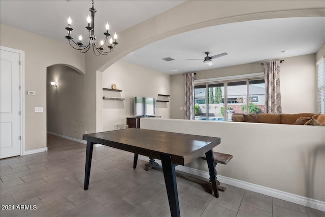 dining area featuring ceiling fan with notable chandelier and hardwood / wood-style floors