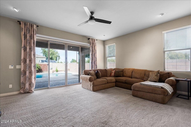 living room featuring carpet floors and ceiling fan