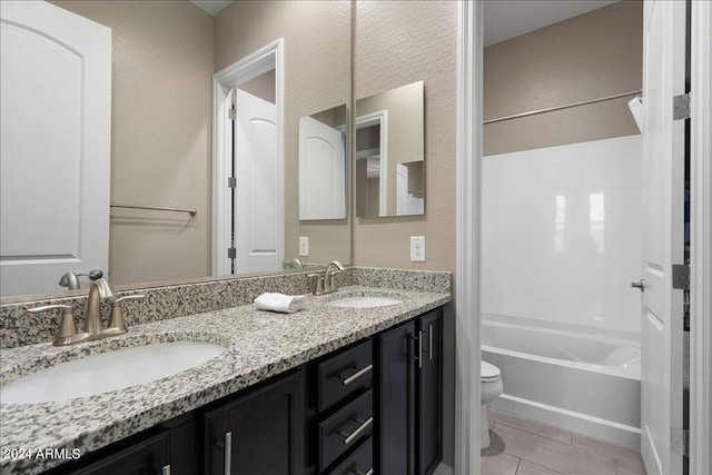 full bathroom featuring tile patterned floors, vanity, toilet, and shower / washtub combination