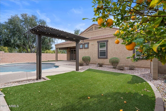 back of property featuring a fenced in pool, a yard, a patio area, and a pergola