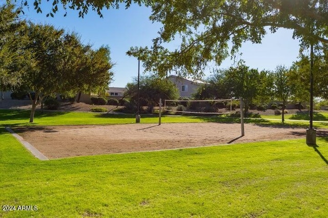 view of community featuring volleyball court and a yard