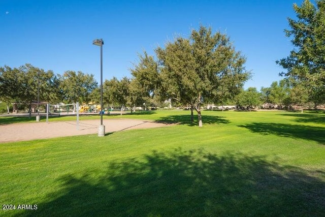 view of community with a yard and volleyball court