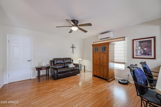 office space with an AC wall unit, ceiling fan, and light hardwood / wood-style flooring