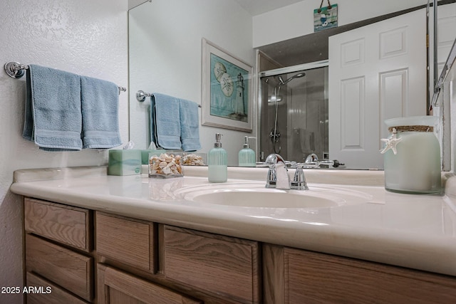 bathroom featuring vanity and a shower with door