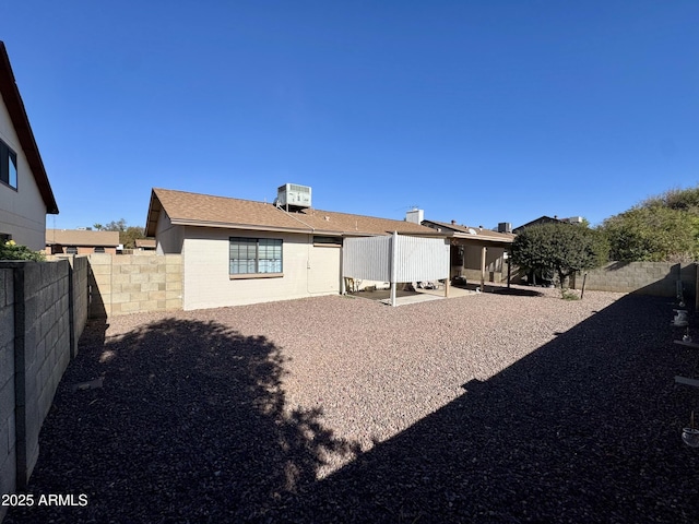 rear view of house featuring central AC unit and a patio area